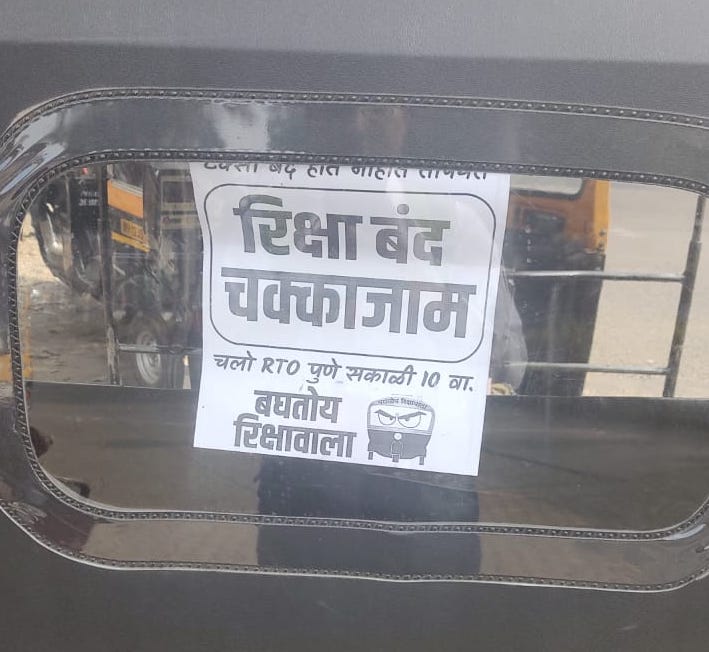 a poster about auto strikes on the back of a rickshaw